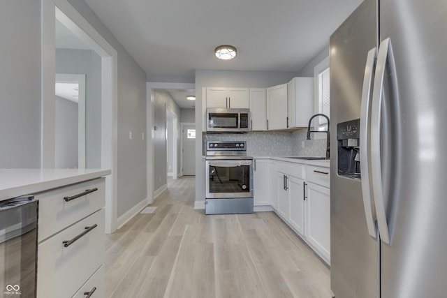 kitchen featuring backsplash, light countertops, beverage cooler, and stainless steel appliances