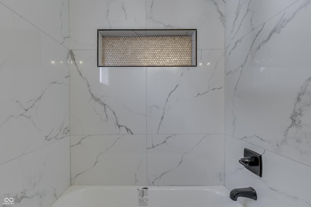 interior details featuring shower / bathing tub combination