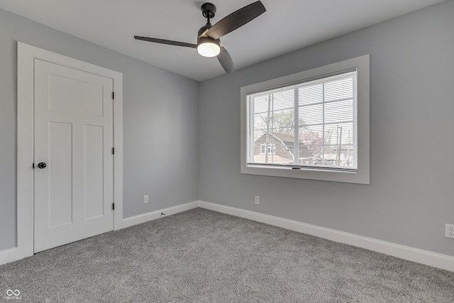 unfurnished bedroom with baseboards, a ceiling fan, and carpet floors