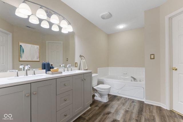 518 Carthage Cir, Westfield, IN 46074 - bathroom featuring a garden tub, wood finished floors, double vanity, and toilet