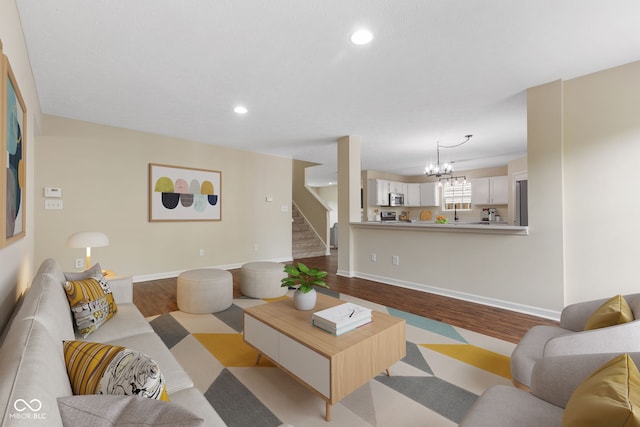 518 Carthage Cir, Westfield, IN 46074 - living area with wood finished floors, a chandelier, stairway, recessed lighting, and baseboards