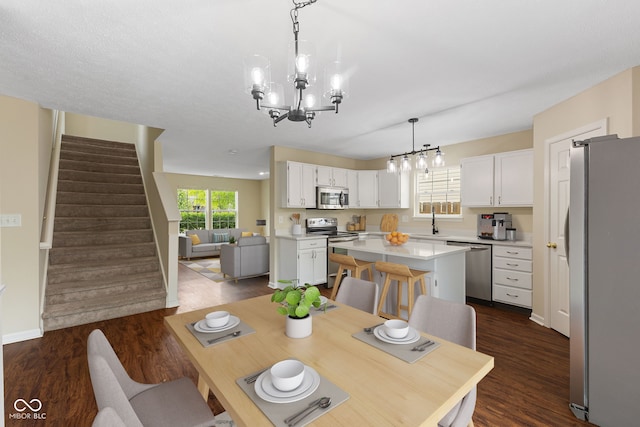 518 Carthage Cir, Westfield, IN 46074 - dining space with a chandelier, dark wood-style flooring, and stairway
