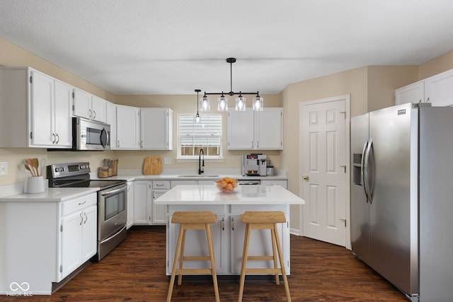 518 Carthage Cir, Westfield, IN 46074 - kitchen with stainless steel appliances, a sink, dark wood-type flooring, and white cabinets