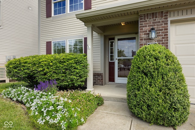 518 Carthage Cir, Westfield, IN 46074 - view of exterior entry featuring an attached garage and brick siding