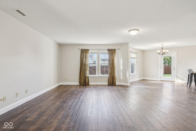 10303 Memorial Knoll Dr, Indianapolis, IN 46234 - unfurnished living room with visible vents, baseboards, a notable chandelier, and dark wood finished floors