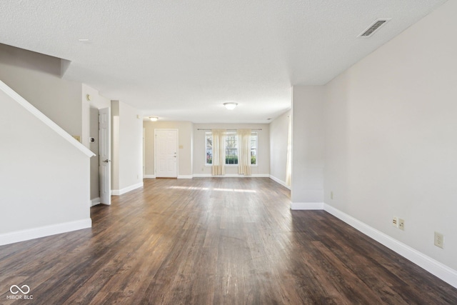 10303 Memorial Knoll Dr, Indianapolis, IN 46234 - unfurnished living room featuring visible vents, baseboards, dark wood-style flooring, a textured ceiling, and stairway
