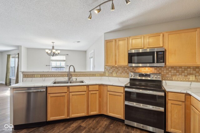 10303 Memorial Knoll Dr, Indianapolis, IN 46234 - kitchen featuring a chandelier, a peninsula, light countertops, stainless steel appliances, and a sink