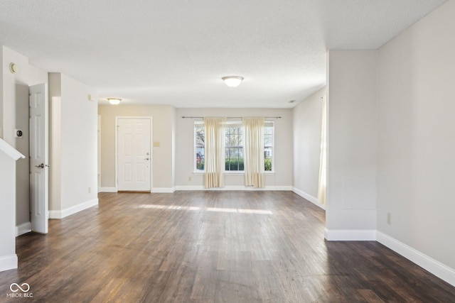 10303 Memorial Knoll Dr, Indianapolis, IN 46234 - unfurnished living room featuring dark wood-style flooring, baseboards, and a textured ceiling