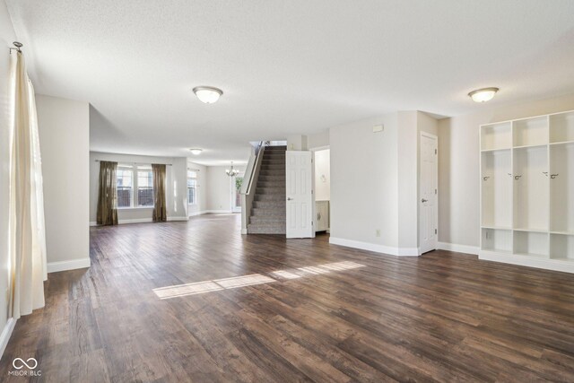 10303 Memorial Knoll Dr, Indianapolis, IN 46234 - unfurnished living room with stairway, dark wood-style flooring, and baseboards