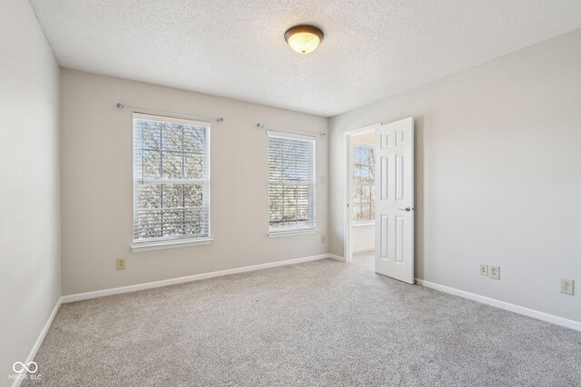 10303 Memorial Knoll Dr, Indianapolis, IN 46234 - carpeted empty room featuring baseboards and a textured ceiling