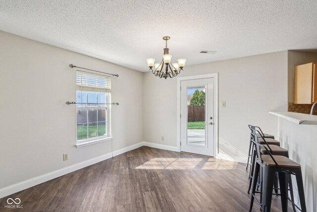 10303 Memorial Knoll Dr, Indianapolis, IN 46234 - unfurnished dining area with visible vents, baseboards, a notable chandelier, and wood finished floors