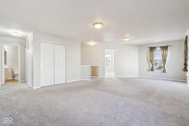 10303 Memorial Knoll Dr, Indianapolis, IN 46234 - unfurnished living room with carpet flooring, a textured ceiling, and baseboards