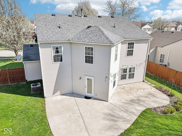 10303 Memorial Knoll Dr, Indianapolis, IN 46234 - rear view of property featuring central AC, a shingled roof, a yard, a patio area, and fence