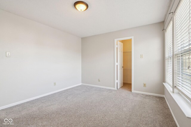 10303 Memorial Knoll Dr, Indianapolis, IN 46234 - carpeted spare room with baseboards and a textured ceiling