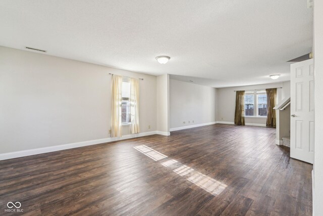 10303 Memorial Knoll Dr, Indianapolis, IN 46234 - unfurnished living room with stairway, visible vents, baseboards, and dark wood finished floors