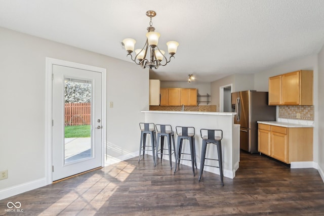 10303 Memorial Knoll Dr, Indianapolis, IN 46234 - kitchen featuring a peninsula, light brown cabinetry, a notable chandelier, and stainless steel refrigerator with ice dispenser