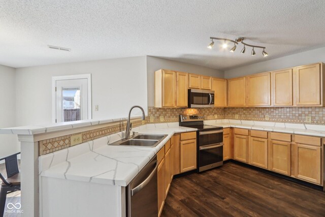 10303 Memorial Knoll Dr, Indianapolis, IN 46234 - kitchen featuring appliances with stainless steel finishes, a peninsula, visible vents, dark wood finished floors, and a sink