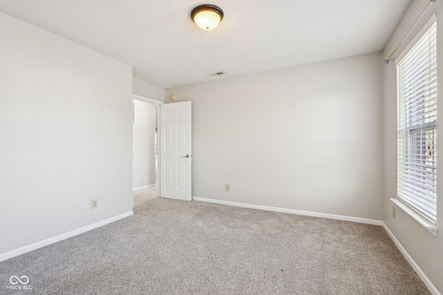 10303 Memorial Knoll Dr, Indianapolis, IN 46234 - carpeted empty room with baseboards, visible vents, and a wealth of natural light