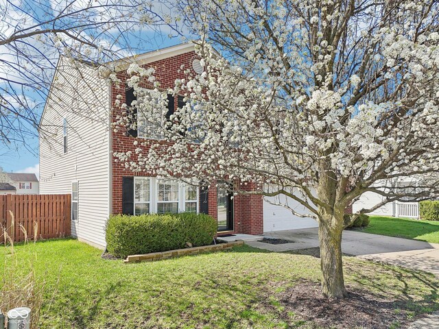 10303 Memorial Knoll Dr, Indianapolis, IN 46234 - view of front facade with a garage, fence, a front lawn, brick siding, and concrete driveway