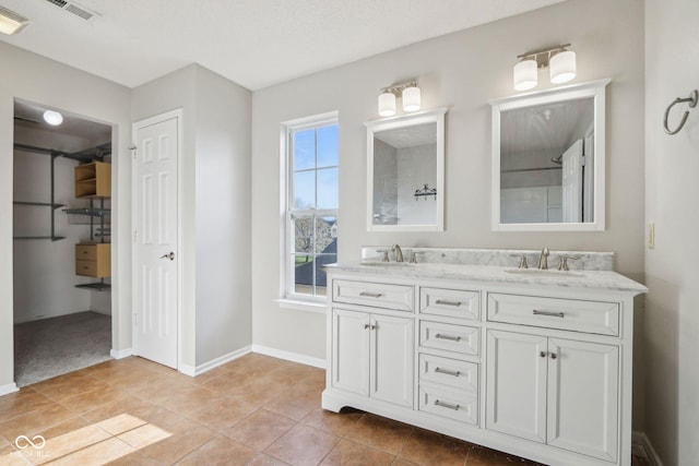 10303 Memorial Knoll Dr, Indianapolis, IN 46234 - bathroom with a sink, visible vents, double vanity, and tile patterned flooring