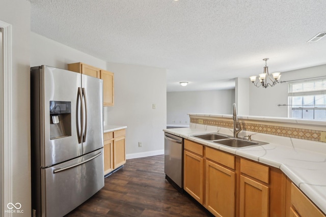 10303 Memorial Knoll Dr, Indianapolis, IN 46234 - kitchen featuring visible vents, an inviting chandelier, a sink, light countertops, and stainless steel appliances