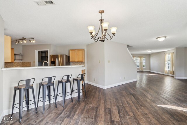 10303 Memorial Knoll Dr, Indianapolis, IN 46234 - kitchen featuring a kitchen breakfast bar, light brown cabinets, a chandelier, stainless steel refrigerator with ice dispenser, and dark wood finished floors