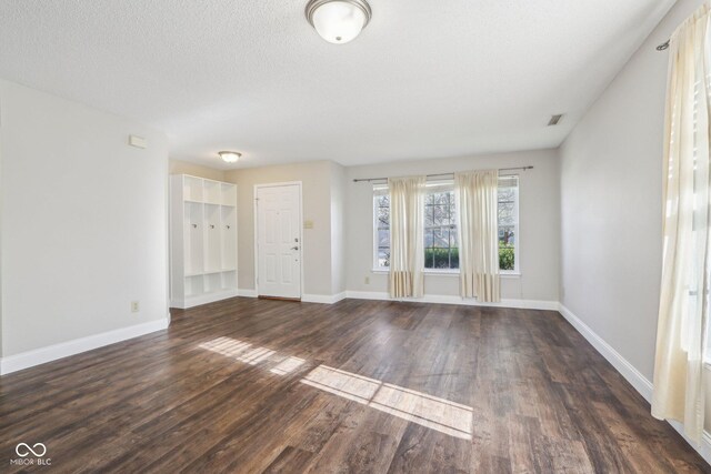 10303 Memorial Knoll Dr, Indianapolis, IN 46234 - unfurnished living room with visible vents, baseboards, a textured ceiling, and dark wood finished floors