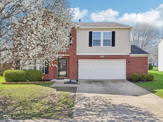 10303 Memorial Knoll Dr, Indianapolis, IN 46234 - traditional home featuring driveway, a front yard, brick siding, a garage, and a shingled roof