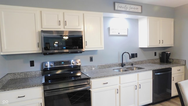 1139 Topp Creek Dr, Indianapolis, IN 46214 - kitchen with stainless steel microwave, range with electric cooktop, dishwasher, a sink, and white cabinetry