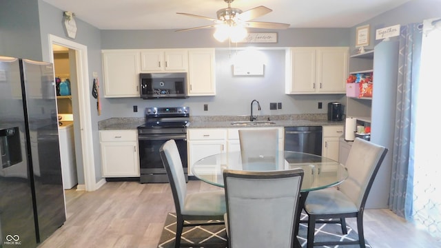 1139 Topp Creek Dr, Indianapolis, IN 46214 - kitchen with stainless steel appliances, a sink, white cabinetry, a ceiling fan, and light wood-type flooring