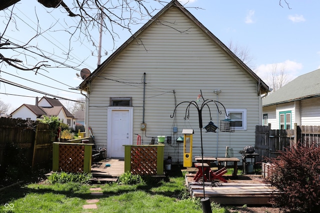 back of house with a wooden deck and fence