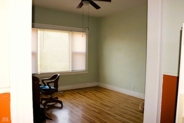 home office featuring baseboards, a ceiling fan, and wood finished floors