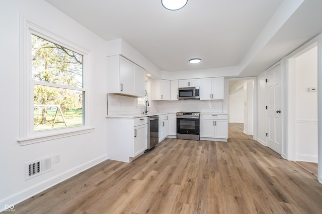 4106 Armon Ct, Carmel, IN 46033 - kitchen with white cabinetry, visible vents, light countertops, and appliances with stainless steel finishes