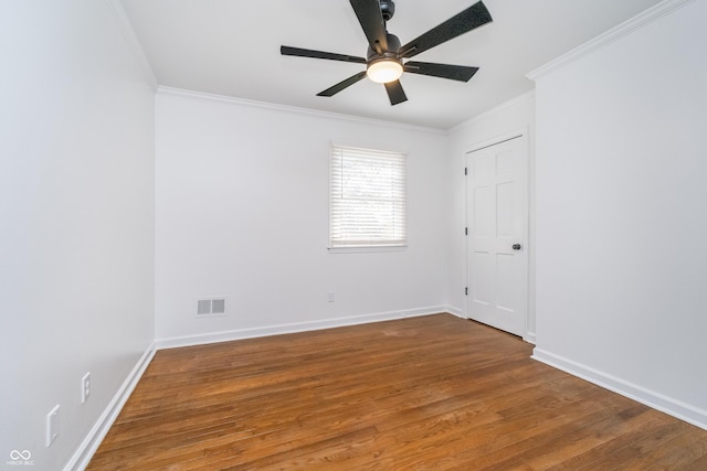 4106 Armon Ct, Carmel, IN 46033 - spare room featuring baseboards, crown molding, a ceiling fan, visible vents, and wood finished floors