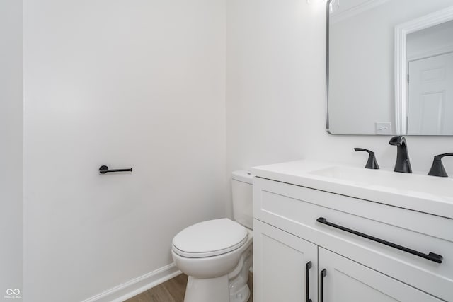 4106 Armon Ct, Carmel, IN 46033 - bathroom featuring vanity, ornamental molding, toilet, wood finished floors, and baseboards