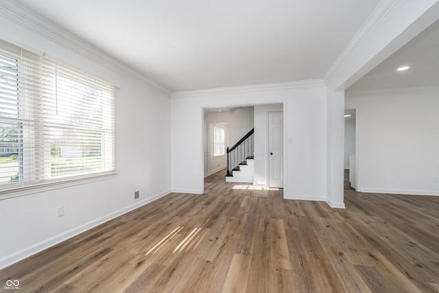 4106 Armon Ct, Carmel, IN 46033 - unfurnished living room with visible vents, baseboards, ornamental molding, stairway, and wood finished floors