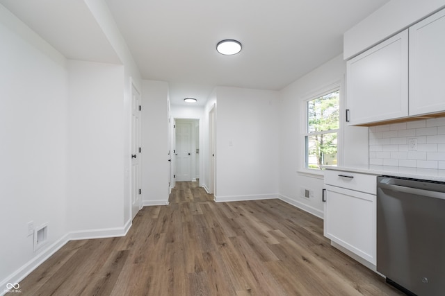 4106 Armon Ct, Carmel, IN 46033 - kitchen with stainless steel dishwasher, light wood finished floors, white cabinets, and light countertops