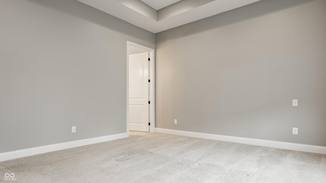 528 Dylan Dr, Carmel, IN 46032 - empty room with light colored carpet, baseboards, and a tray ceiling