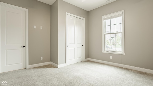 528 Dylan Dr, Carmel, IN 46032 - unfurnished bedroom with light colored carpet, multiple windows, and baseboards