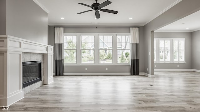 528 Dylan Dr, Carmel, IN 46032 - unfurnished living room featuring crown molding, a fireplace, light wood-type flooring, ceiling fan, and recessed lighting