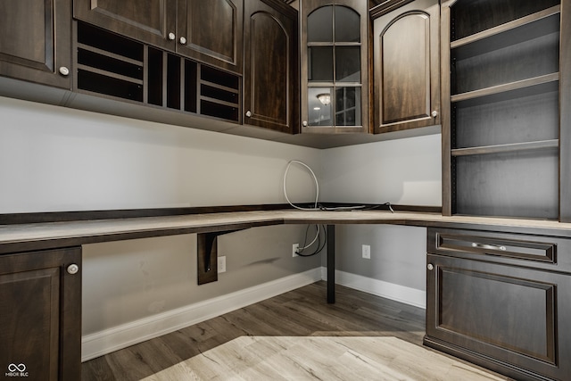 528 Dylan Dr, Carmel, IN 46032 - kitchen featuring baseboards, dark brown cabinetry, wood finished floors, and glass insert cabinets