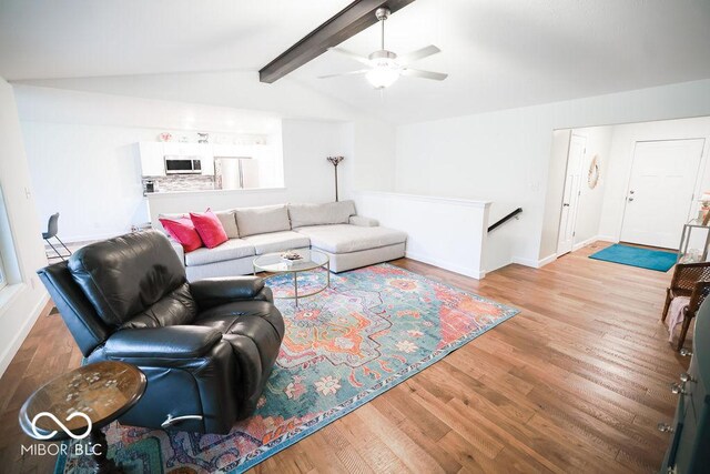 8917 N Old State Road 37, Bloomington, IN 47408 - living area with wood finished floors, ceiling fan, baseboards, and vaulted ceiling with beams