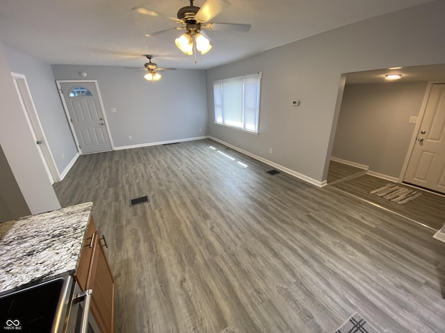 1546 Kappes St, Indianapolis, IN 46221 - unfurnished living room with visible vents, ceiling fan, wood finished floors, and baseboards