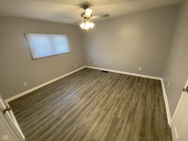 1546 Kappes St, Indianapolis, IN 46221 - empty room with dark wood-style flooring, baseboards, a ceiling fan, and visible vents