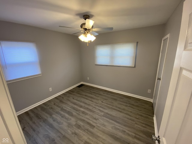 1546 Kappes St, Indianapolis, IN 46221 - unfurnished bedroom with ceiling fan, baseboards, and dark wood finished floors