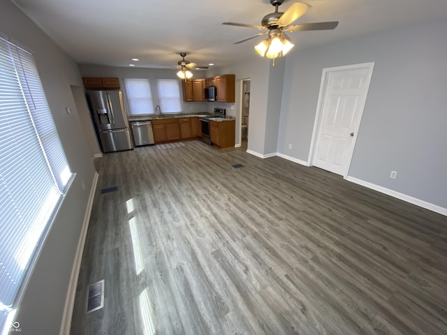 1546 Kappes St, Indianapolis, IN 46221 - kitchen featuring dark wood-type flooring, a ceiling fan, appliances with stainless steel finishes, a sink, and baseboards