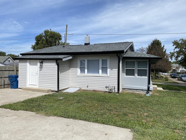1546 Kappes St, Indianapolis, IN 46221 - view of front of property featuring a front yard, a chimney, fence, and a shingled roof
