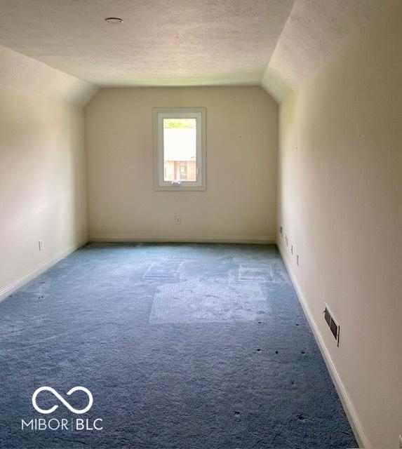 3504 Inverness Blvd, Carmel, IN 46032 - additional living space with vaulted ceiling, carpet, a textured ceiling, and baseboards