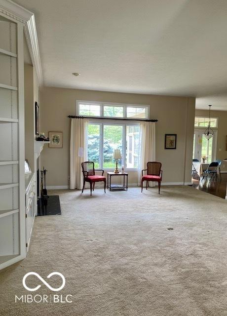 3504 Inverness Blvd, Carmel, IN 46032 - sitting room featuring baseboards, light colored carpet, and a fireplace