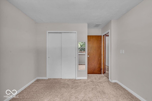 11054 N Shelby 490 W, New Palestine, IN 46163 - unfurnished bedroom featuring carpet floors, a closet, and a textured ceiling